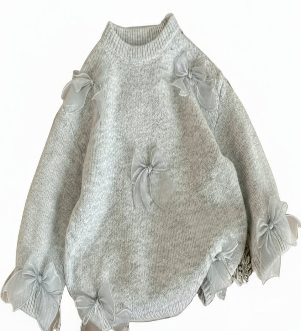 trui in beige of lichtgrijs met tule strikjes. Heel zacht materiaal.