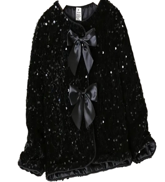 Jasje voorzien van zwarte pailletten en strikjes