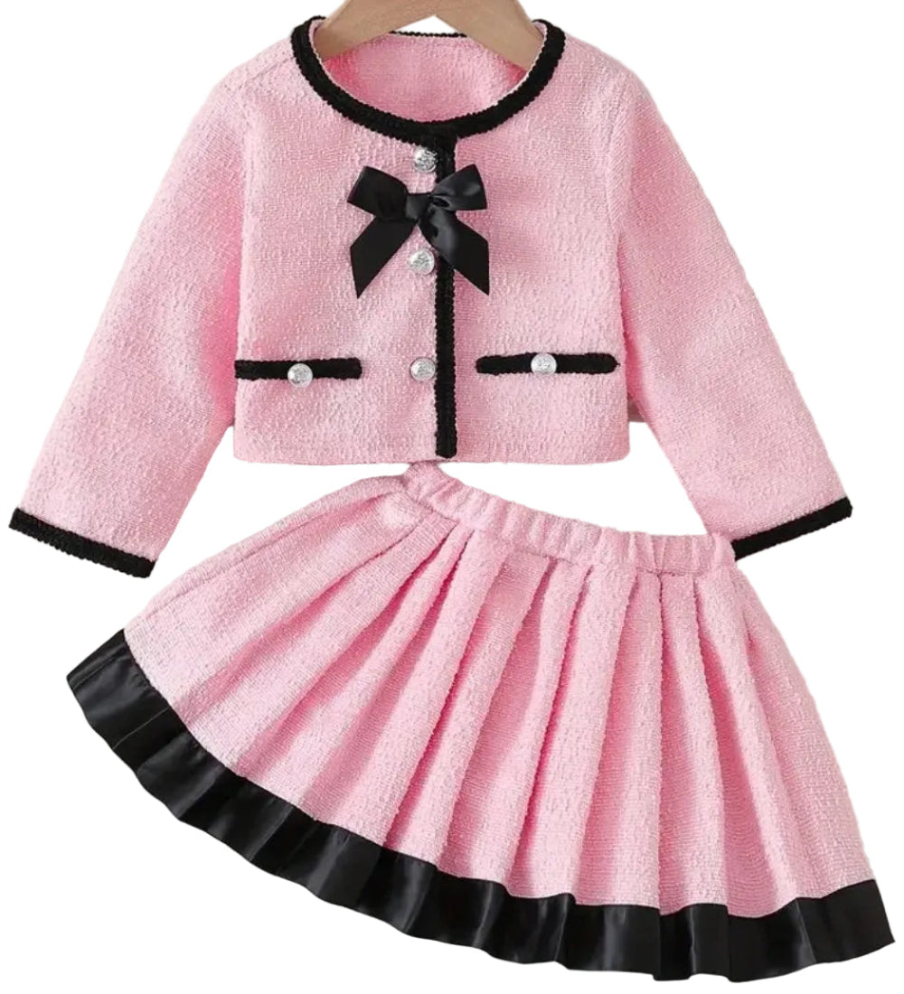 Feestelijk setje kort jasje met rokje. Roze met zwarte randen en een strikje op het jasje.